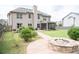 Backyard with a custom fire pit, stone walkway, grass, and access to the patio area at 3739 In Bloom Way, Auburn, GA 30011