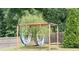 Backyard with pergola swings and mature trees adding privacy to the landscaped yard at 3739 In Bloom Way, Auburn, GA 30011