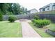 Backyard featuring a fire pit with a stone walkway and beautiful landscaping at 3739 In Bloom Way, Auburn, GA 30011