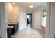 Large primary bathroom with double granite vanity, tile floor, and a soaking tub at 3739 In Bloom Way, Auburn, GA 30011