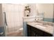 Bathroom featuring a granite countertop, dark wood vanity, and a striped shower curtain at 3739 In Bloom Way, Auburn, GA 30011