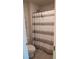 Cozy bathroom with white and gray striped shower curtain and neutral tile flooring at 3739 In Bloom Way, Auburn, GA 30011