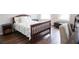 Traditional bedroom with wood floors and trim, including bedside tables and lamps at 3739 In Bloom Way, Auburn, GA 30011