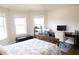 Sunlit bedroom featuring a bed, desk, and windows, ideal for work or relaxation at 3739 In Bloom Way, Auburn, GA 30011