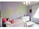 bedroom with a painted wall, white dresser, and natural light at 3739 In Bloom Way, Auburn, GA 30011