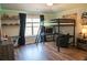 Bedroom featuring a bunk bed with desk, hardwood floors, and a bright light fixture at 3739 In Bloom Way, Auburn, GA 30011