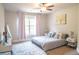 Inviting bedroom with soft lighting, carpeted floor, and a comfortable bed near a bright window at 3739 In Bloom Way, Auburn, GA 30011