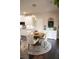 Bright dining area features a round wooden table, stylish chairs, and a modern chandelier at 3739 In Bloom Way, Auburn, GA 30011