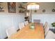 Bright dining room with a large table, chandelier, and wainscoting at 3739 In Bloom Way, Auburn, GA 30011