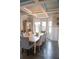Elegant dining room featuring a chandelier, decorative ceiling, and ample seating space for gatherings at 3739 In Bloom Way, Auburn, GA 30011