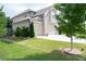 Well-maintained home exterior features a three-car garage, lush green lawn, and mature landscaping at 3739 In Bloom Way, Auburn, GA 30011