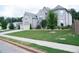Charming home with lush green lawn and mature trees offering great curb appeal on a tree lined street at 3739 In Bloom Way, Auburn, GA 30011