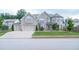 Stunning two-story home with a three-car garage, stone and siding details, and a well-manicured lawn at 3739 In Bloom Way, Auburn, GA 30011