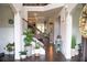 Bright and airy foyer with hardwood floors, staircase, and views of the living area enhances the home's appeal at 3739 In Bloom Way, Auburn, GA 30011