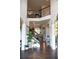 Grand two-story foyer with hardwood floors, staircase, and elegant decor, creates an inviting atmosphere at 3739 In Bloom Way, Auburn, GA 30011