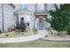 Inviting front entrance with beautifully landscaped walkway leading to a decorative front door at 3739 In Bloom Way, Auburn, GA 30011