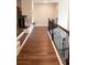 Hallway with wood floors and wrought iron railing, adding style and safety at 3739 In Bloom Way, Auburn, GA 30011