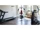 Well-equipped home gym featuring a treadmill, elliptical machine, and weight training equipment at 3739 In Bloom Way, Auburn, GA 30011
