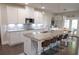 Bright kitchen with granite counters, white cabinets, and a large island with bar seating at 3739 In Bloom Way, Auburn, GA 30011