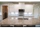 White kitchen with stainless appliances, granite countertops and large island at 3739 In Bloom Way, Auburn, GA 30011