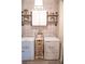 Well-organized laundry room with washer, dryer, and decorative shelving at 3739 In Bloom Way, Auburn, GA 30011