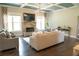 Comfortable living room featuring a stone fireplace, large windows, and hardwood floors at 3739 In Bloom Way, Auburn, GA 30011