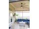 Relaxing screened patio with ceiling fan and comfortable seating area with outdoor furniture at 3739 In Bloom Way, Auburn, GA 30011