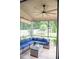 Relaxing screened patio with comfortable seating area, ceiling fan, and backyard view at 3739 In Bloom Way, Auburn, GA 30011