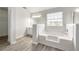 Bathroom featuring a soaking tub and vanity with wood floors at 3772 Sunbridge Dr, Snellville, GA 30039