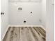 Dedicated laundry room with vinyl flooring, utility connections, and white trim at 3772 Sunbridge Dr, Snellville, GA 30039