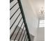 Bright foyer staircase with modern wrought iron railing and chandelier for a luxurious entryway at 3772 Sunbridge Dr, Snellville, GA 30039
