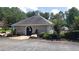 View of the community clubhouse with convenient parking and lush landscaping at 3920 Knotts Pass Rd, Snellville, GA 30039