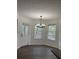Bright dining area with modern chandelier, wood-look flooring, and ample natural light from the surrounding windows at 3920 Knotts Pass Rd, Snellville, GA 30039