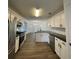 Modern kitchen with stainless steel appliances, white cabinetry, granite countertops, and an island at 3920 Knotts Pass Rd, Snellville, GA 30039