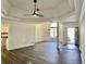 Open living room with wood-look floors, decorative ceilings, and views to dining area and front entryway at 3920 Knotts Pass Rd, Snellville, GA 30039