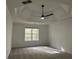 Spacious bedroom with decorative trey ceilings, a ceiling fan, and large windows for natural light at 3920 Knotts Pass Rd, Snellville, GA 30039