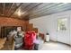 Unfinished basement with brick accent wall and an exit door to the backyard at 4944 Dovecote Trl, Suwanee, GA 30024