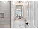 Bathroom features a vanity with mirror, marble countertop and white tile backsplash at 4944 Dovecote Trl, Suwanee, GA 30024