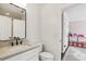 Bright bathroom with white cabinets, black fixtures, a modern toilet, and opens to a bedroom at 4944 Dovecote Trl, Suwanee, GA 30024