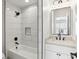Modern bathroom features a bathtub, shower, and vanity with a marble countertop at 4944 Dovecote Trl, Suwanee, GA 30024