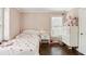 Bedroom features a white bed, dresser, and a window for natural light at 4944 Dovecote Trl, Suwanee, GA 30024