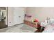 bedroom features a double door closet, plush bunny rug, pink accents, and light pink walls at 4944 Dovecote Trl, Suwanee, GA 30024