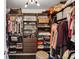 Walk-in closet with custom shelves and hanging rods for organized storage and plenty of space at 4944 Dovecote Trl, Suwanee, GA 30024
