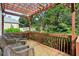Outdoor deck with pergola and wicker chairs offering a relaxing space at 4944 Dovecote Trl, Suwanee, GA 30024