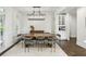 Elegant dining room with modern lighting, perfect for entertaining with stylish decor and ample seating at 4944 Dovecote Trl, Suwanee, GA 30024