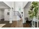 Bright foyer with hardwood floors and staircase, creating a welcoming entrance with natural light and inviting design at 4944 Dovecote Trl, Suwanee, GA 30024