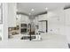 Bright kitchen features white cabinets, stone counters, stainless steel appliances, and modern fixtures at 4944 Dovecote Trl, Suwanee, GA 30024
