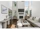 Spacious living room with fireplace and large windows, creating a cozy atmosphere with ample natural light and modern decor at 4944 Dovecote Trl, Suwanee, GA 30024