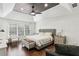 Large main bedroom with a ceiling fan, hardwood floors and a seating area at 4944 Dovecote Trl, Suwanee, GA 30024