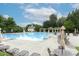 Community pool with lounge chairs and tables, offering a relaxing amenity for residents at 4944 Dovecote Trl, Suwanee, GA 30024